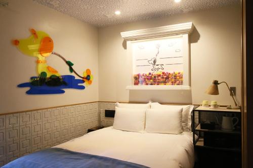 Postel nebo postele na pokoji v ubytování ピーナッツホテル/PEANUTS HOTEL