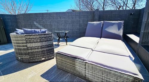 a bed sitting next to a fence with a table at 8Room-千葉県八街市 in Yachimata