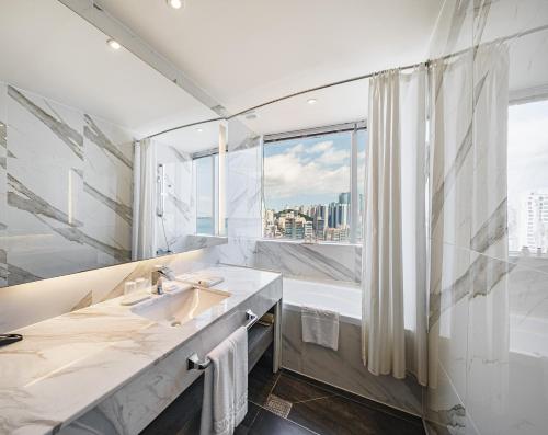 a bathroom with a sink and a large window at Kent Hotel Gwangalli by Kensington in Busan