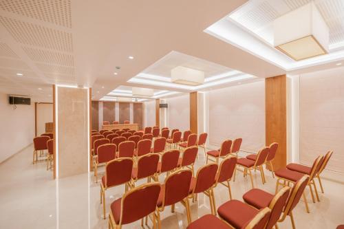 a conference room with a row of chairs and a table at Loft Business Hotel in Kakkanad