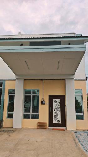 a building with awning over the door of it at Teratak Seri Kelubi Homestay in Jasin