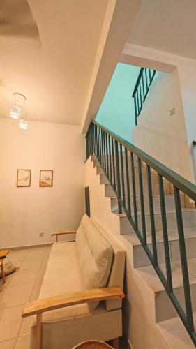 a staircase in a house with a couch at Teratak Seri Kelubi Homestay in Jasin
