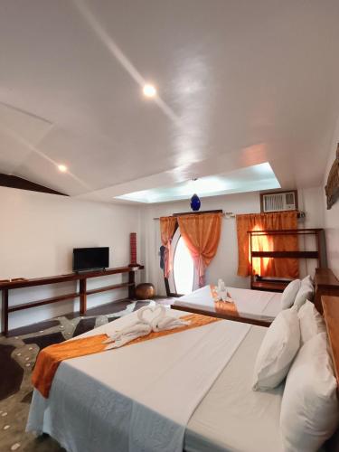 a large white bed in a room with a window at Casa de Arte in Boracay