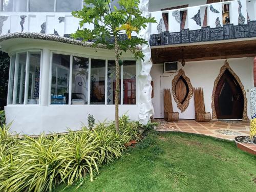 a house with a large window and a porch at Casa de Arte in Boracay