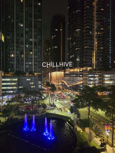 a view of a city at night with a fountain at Prime BGC Condo: Uptown Mall & Hyatt #ournw21n in Manila