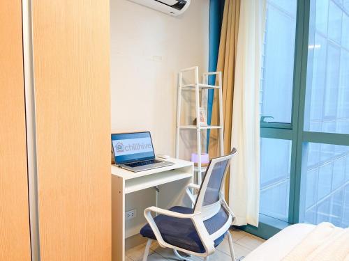a room with a desk with a laptop and a chair at Luxury BGC Condo Across Uptown Mall #ournw19a in Manila