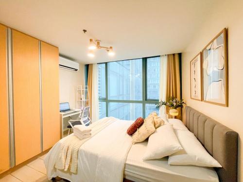 a bedroom with a bed and a large window at Luxury BGC Condo Across Uptown Mall #ournw19a in Manila