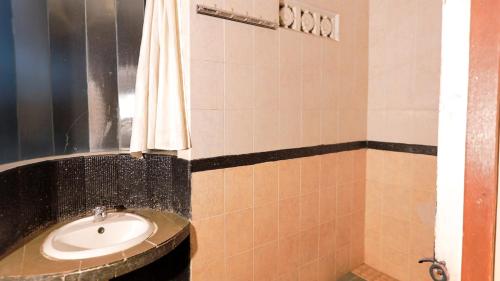 a bathroom with a sink and a shower at Lembah Gunung Kujang by ARBA in Gunungtua
