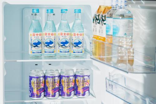 a refrigerator filled with lots of bottles of water at THE TOKI fujikawaguchiko in Fujikawaguchiko