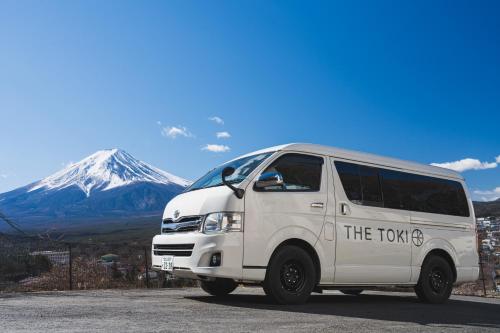 a white van parked in front of a mountain at THE TOKI fujikawaguchiko in Fujikawaguchiko