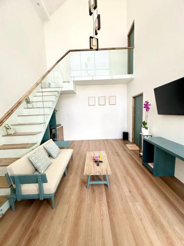 a living room with a couch and a table at Gauri Vasanta Villa with Private Pool Yogyakarta in Yogyakarta