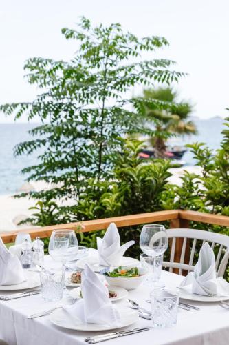 a table with a white table cloth and glasses and food at Fun & Sun Club Saphire in Tekirova