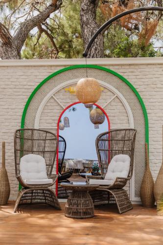 a patio with two chairs and a table and a mirror at Fun & Sun Club Saphire in Tekirova