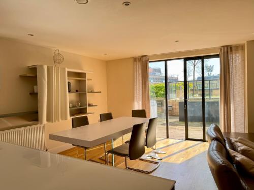 a kitchen and dining room with a table and chairs at Luxury 3-BR near Tower Bridge Family & Business Ready in London