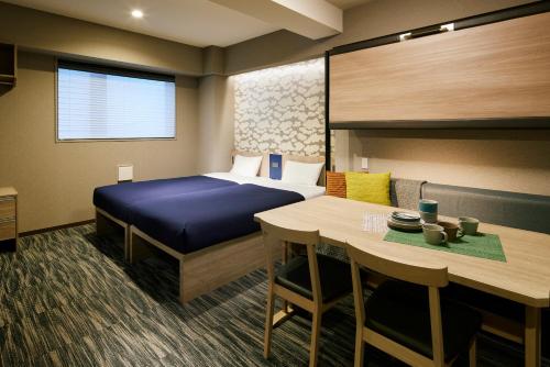 a hotel room with a bed and a table at Minn Asakusa Kappabashi in Tokyo