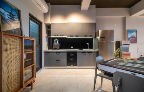 a kitchen with a sink and a refrigerator at 歸巢民宿 Homecoming in Jiaoxi