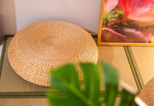 a straw hat sitting on a table next to a picture at 歸巢民宿 Homecoming in Jiaoxi