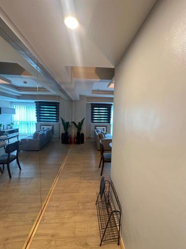 a large living room with a glass wall at BSA Twin Tower - Exquisite Stays Private 2BR Rental in Manila