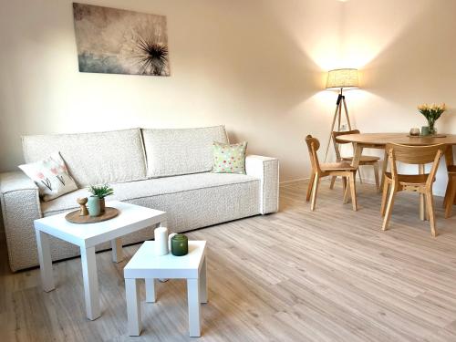 a living room with a couch and a table at Ferienwohnung Dorfliebe Kirchdorf in Kirchdorf