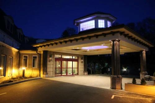 a house with a building on top of it at night at Norwalk Inn & Conference Center in Norwalk