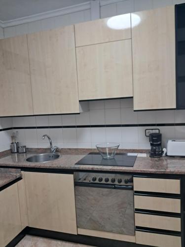 a kitchen with a sink and a counter top at Casa Javi in Ojedo
