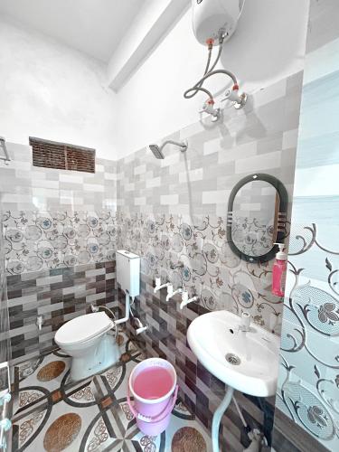 a bathroom with a toilet and a sink at Kashi Bliss Apartment in Varanasi