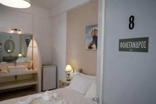 a hotel room with a bed and a sink at Giasemi Rooms in Livadi Astypalaias