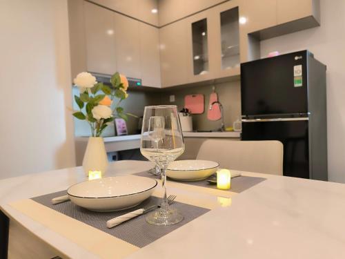a kitchen with a table with a wine glass on it at Vinhomes Smartcity- Căn hộ dịch vụ nguyên căn in Phú Thú