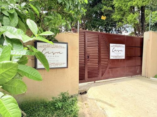 a fence with a gate with a sign on it at Casa Tamara Lodge in Kitwe