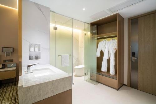 a bathroom with a sink and a toilet at Victoria Hotel Guangzhou Zhujiang New Town - Free shuttle bus during Canton Fair period in Guangzhou