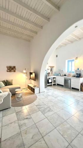 a large living room with a large stone floor at ''TSI TSI' traditional home & private Pool' in Kalithies