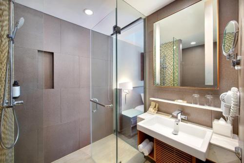 a bathroom with a sink and a shower at Mercure Bali Legian in Legian