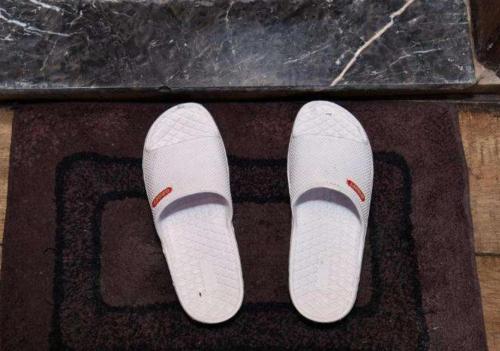 a pair of white shoes on top of a rug at Hotel N Maharani in New Delhi