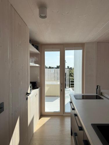 a kitchen with a counter and a door to a balcony at Villa Aria Buqez Vita in Drage