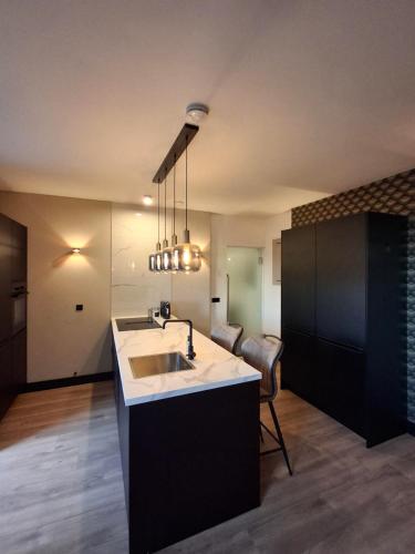 a kitchen with a sink and a counter top at Vakantiewoning Hem in Hem