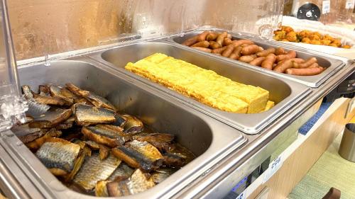 a buffet with trays of different types of food at Toyoko Inn Hokkaido Sapporo-eki Minami-guchi in Sapporo