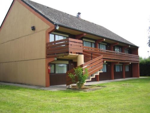 a large building with a grassy yard in front of it at Campanile Rouen Nord - Mont-Saint-Aignan in Mont-Saint-Aignan
