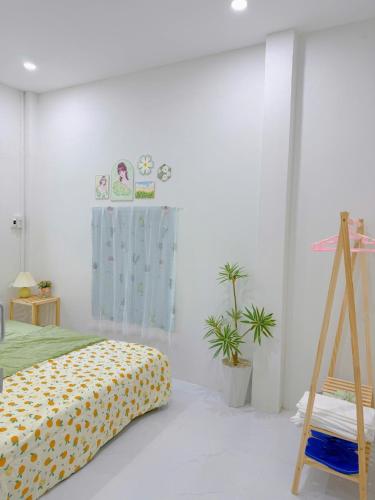 a bedroom with a bed and plants in it at Yang Homestay Phan Thiết in Phan Thiet