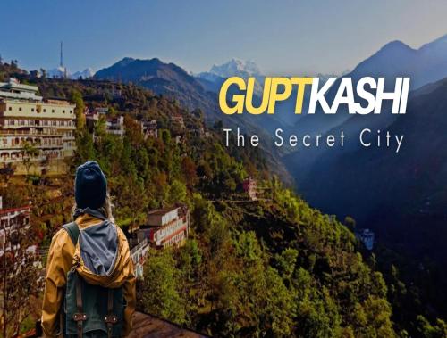 a person with a backpack standing on top of a mountain at LA Riqueza Sushanti Retreat - Mountain View Rooms with Balcony # Pure Veg Restaurant # Jain Food Available # Parking # Customer's choice Hotel in Gupta Kāshi