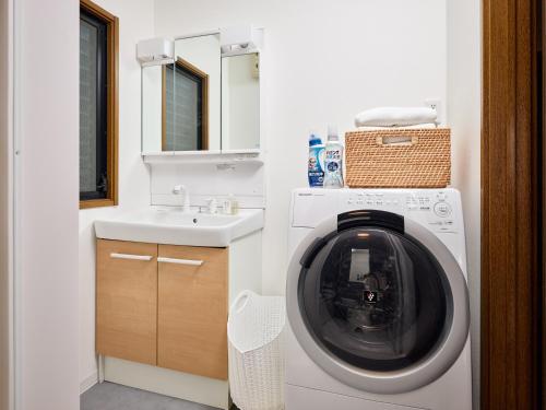a bathroom with a washing machine and a sink at Ukiyoe House 3BR 75m2 with 60m2 deck Sauna in Tokyo
