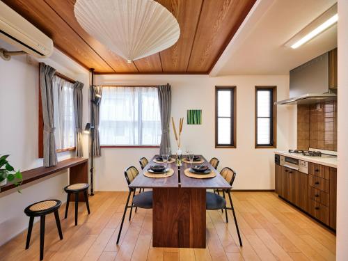 a kitchen and dining room with a table and chairs at Ukiyoe House 3BR 75m2 with 60m2 deck Sauna in Tokyo