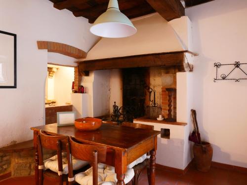 a dining room with a table and a fireplace at La Meridiana in Montefioralle in Greve in Chianti