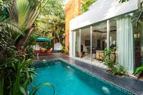 a swimming pool in the middle of a house at La Zamora, 3BHK Villas near Vagator & Anjuna Beach, North Goa with Private Pool, Garden, Terrace & Security in Assagao