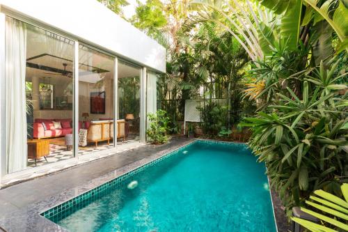 a swimming pool in the backyard of a house at La Zamora, 3BHK Villas near Vagator & Anjuna Beach, North Goa with Private Pool, Garden, Terrace & Security in Assagao