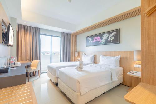 Postel nebo postele na pokoji v ubytování Horison Le Aman Bali