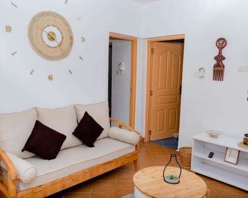 a living room with a couch and a table at Pinebreeze Holiday Resort in Nyali