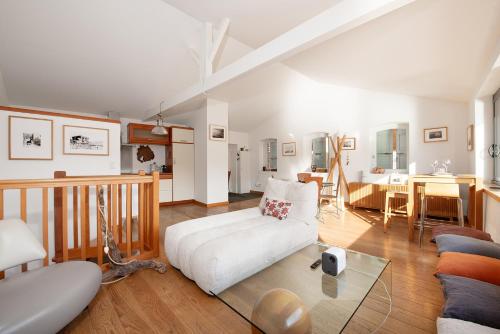 a living room with a white couch and a table at Maison Tendat in Albi