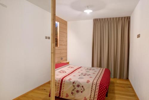 a bedroom with a bed with a mirror in it at Appartamento Stella Alpina in Chiesa in Valmalenco