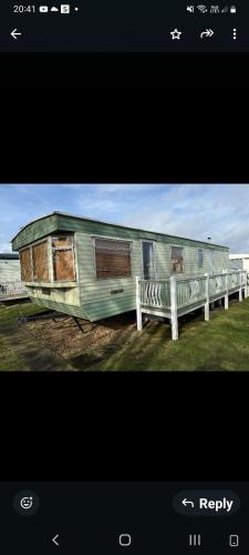 a train car sitting next to a white bench at S&l caravan holidays in Winthorpe