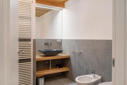 a bathroom with a sink and a toilet at Appartamento Stella Alpina in Chiesa in Valmalenco